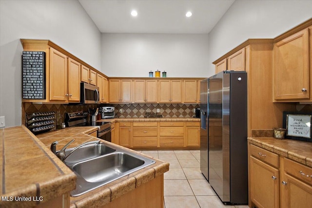 1510 Independence Blvd, Flowood, MS 39232 - kitchen with stainless steel appliances, decorative backsplash, light tile patterned floors, a sink, and recessed lighting