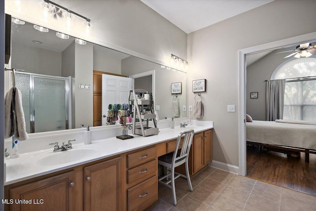 1510 Independence Blvd, Flowood, MS 39232 - ensuite bathroom featuring double vanity, tile patterned flooring, ceiling fan, a stall shower, and baseboards