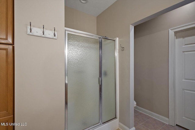 1510 Independence Blvd, Flowood, MS 39232 - bathroom featuring a shower stall, toilet, tile patterned flooring, and baseboards