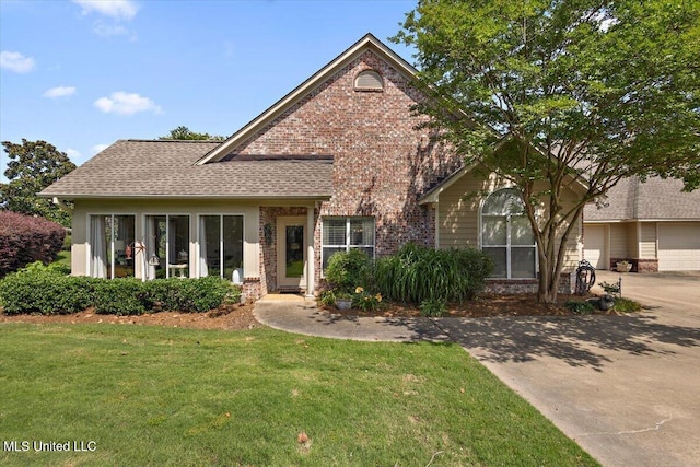 1510 Independence Blvd, Flowood, MS 39232 - view of front of house featuring brick siding, a front lawn, roof with shingles, and concrete driveway