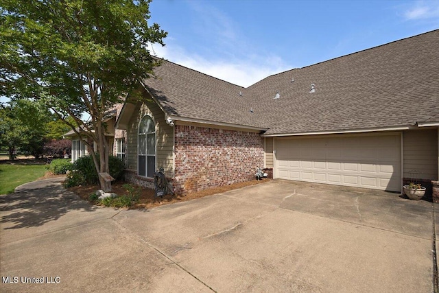 1510 Independence Blvd, Flowood, MS 39232 - view of home's exterior featuring brick siding, driveway, a shingled roof, and a garage