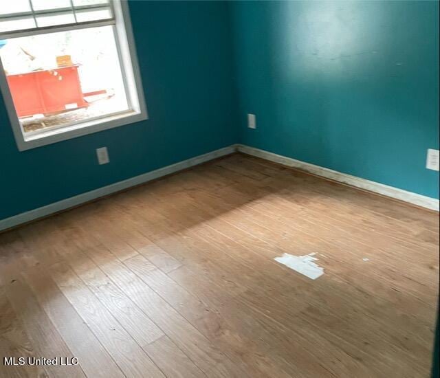 empty room with hardwood / wood-style floors