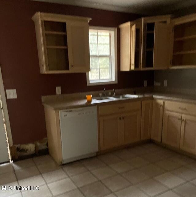 kitchen featuring white dishwasher, sink, and light brown cabinetry