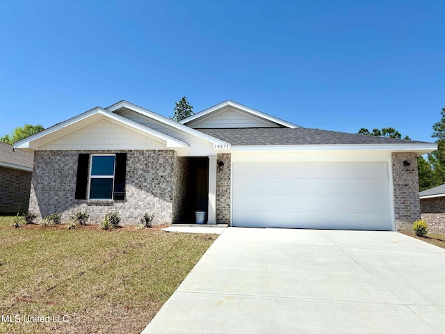 single story home featuring concrete driveway, a front yard, brick siding, and a garage