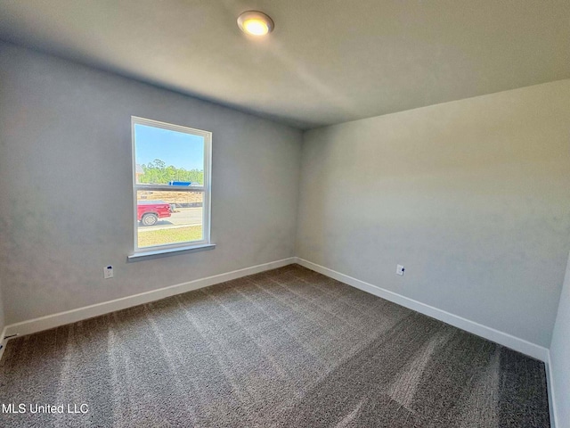 empty room with carpet floors and baseboards
