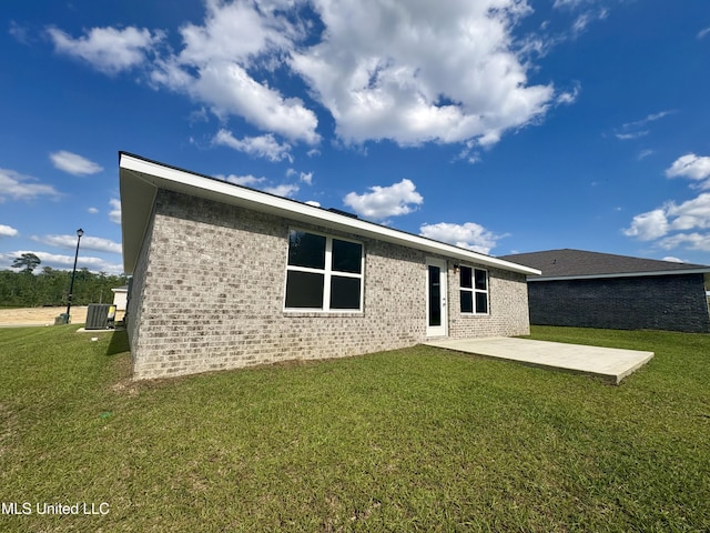 18071 Tiffany Renee Dr, Gulfport, MS 39503 - rear view of house with a patio area, central AC, a lawn, and brick siding