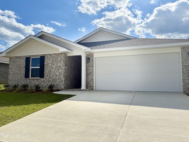 18071 Tiffany Renee Dr, Gulfport, MS 39503 - ranch-style home featuring driveway, a garage, a front yard, and brick siding