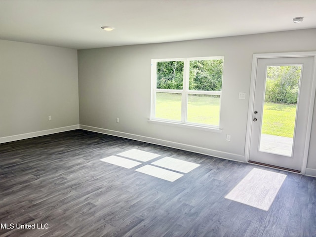 18071 Tiffany Renee Dr, Gulfport, MS 39503 - spare room with plenty of natural light, baseboards, and dark wood-style flooring