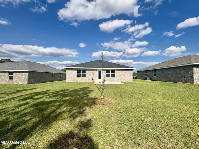 18071 Tiffany Renee Dr, Gulfport, MS 39503 - rear view of house featuring a lawn and central air condition unit