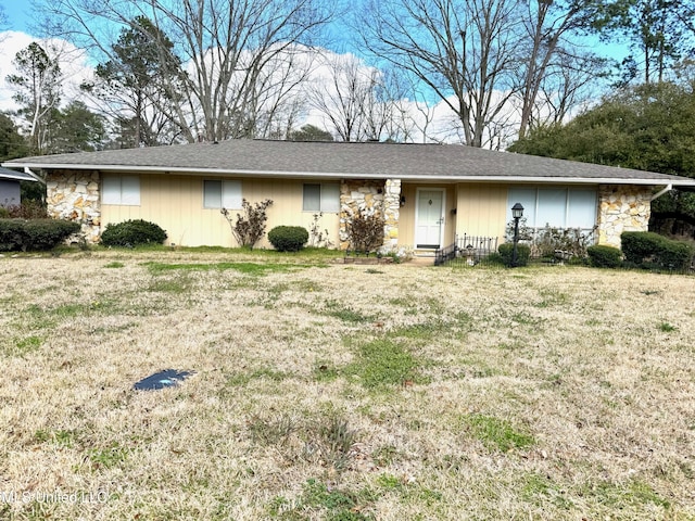 ranch-style house with stone siding and a front yard