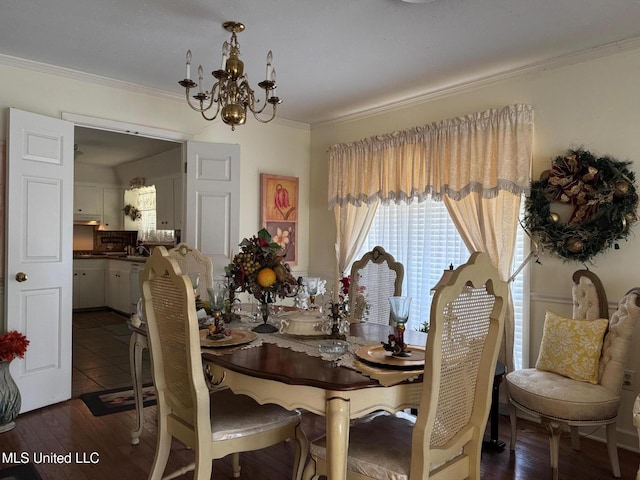 dining space featuring a chandelier, dark wood finished floors, and crown molding