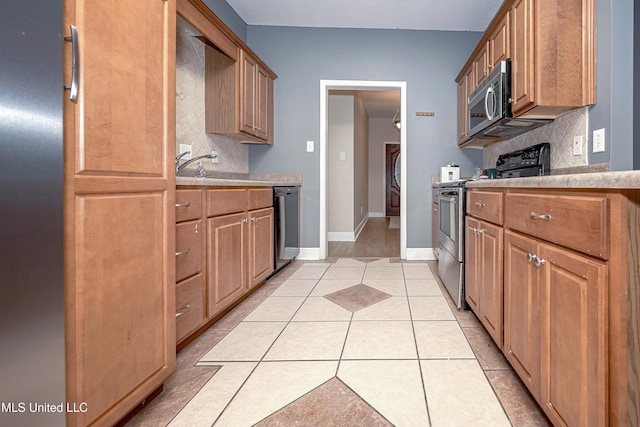 8002 Martin Bluff Rd, Gautier, MS 39553 - kitchen with stainless steel appliances, decorative backsplash, and light countertops