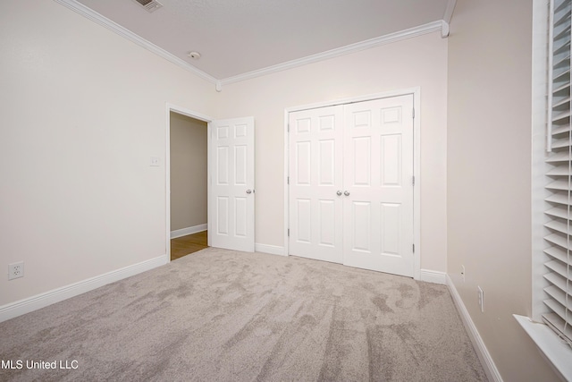 8002 Martin Bluff Rd, Gautier, MS 39553 - unfurnished bedroom with crown molding, carpet floors, and a closet