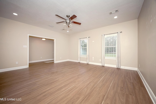 8002 Martin Bluff Rd, Gautier, MS 39553 - empty room with ceiling fan, wood finished floors, a textured ceiling, and recessed lighting