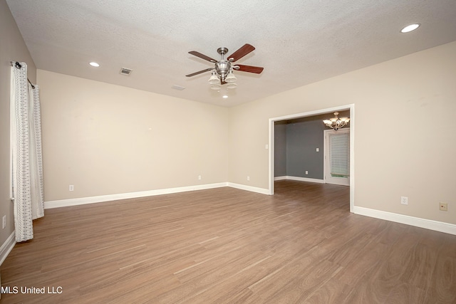 8002 Martin Bluff Rd, Gautier, MS 39553 - unfurnished room with a ceiling fan, wood finished floors, a textured ceiling, a chandelier, and recessed lighting