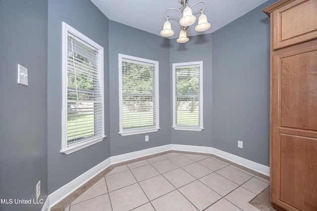 8002 Martin Bluff Rd, Gautier, MS 39553 - unfurnished dining area featuring a chandelier and light tile patterned floors