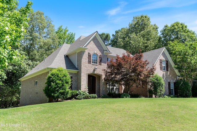 7672 N Rigmoore Pt, Olive Branch, MS 38654 - view of front of home featuring brick siding, a front yard, and roof with shingles