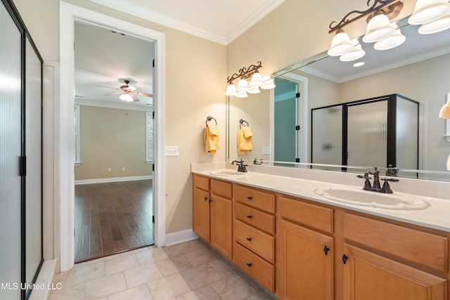 7672 N Rigmoore Pt, Olive Branch, MS 38654 - full bathroom with a ceiling fan, double vanity, a stall shower, crown molding, and baseboards