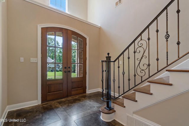 7672 N Rigmoore Pt, Olive Branch, MS 38654 - entryway with french doors, healthy amount of natural light, baseboards, stairway, and a towering ceiling
