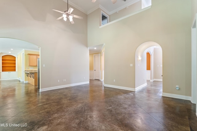 7672 N Rigmoore Pt, Olive Branch, MS 38654 - unfurnished living room featuring a ceiling fan, arched walkways, a high ceiling, concrete flooring, and baseboards