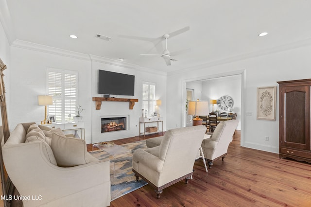 131 Camden Trl, Madison, MS 39110 - living area with wood finished floors, ornamental molding, a glass covered fireplace, a ceiling fan, and recessed lighting