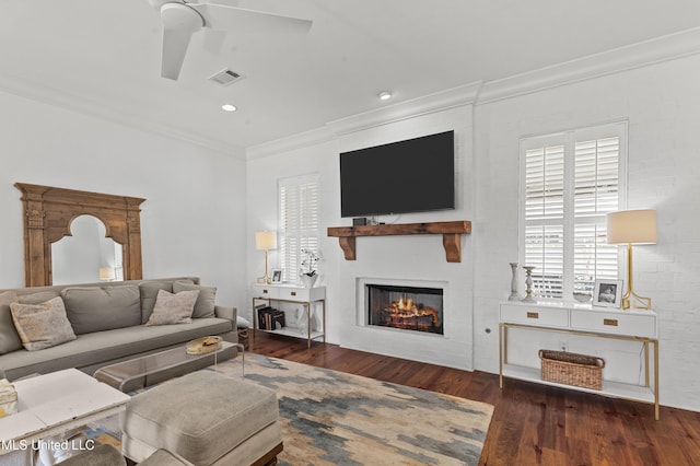 131 Camden Trl, Madison, MS 39110 - living area featuring ornamental molding, ceiling fan, wood finished floors, and a warm lit fireplace