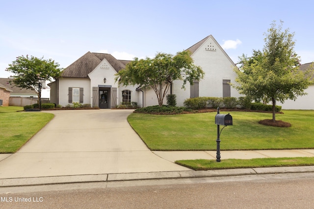 131 Camden Trl, Madison, MS 39110 - french country inspired facade with a front yard, concrete driveway, and stucco siding