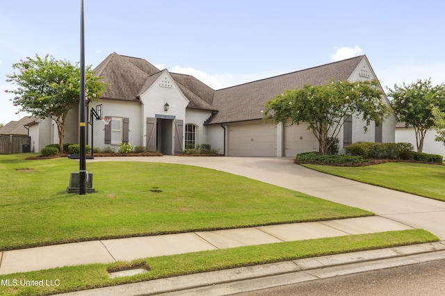 131 Camden Trl, Madison, MS 39110 - french provincial home with an attached garage, driveway, a front yard, and stucco siding