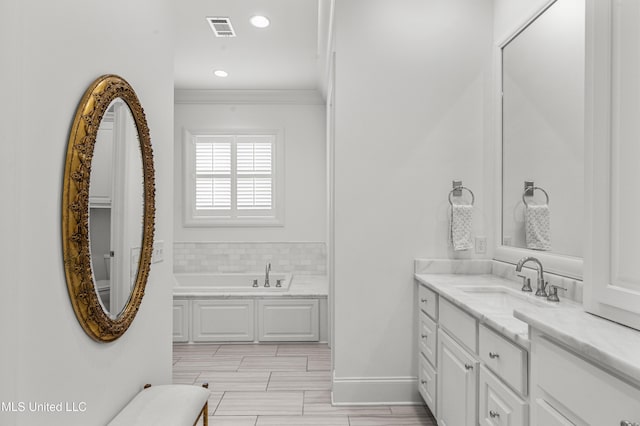 131 Camden Trl, Madison, MS 39110 - bathroom with a garden tub, vanity, ornamental molding, and recessed lighting
