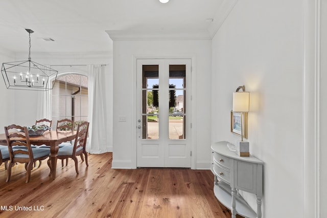 131 Camden Trl, Madison, MS 39110 - foyer with a chandelier, crown molding, and light wood-style flooring