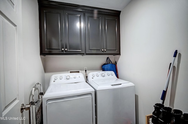 laundry room with cabinets and washing machine and clothes dryer