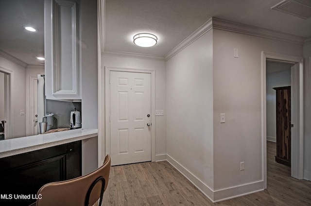 interior space with light hardwood / wood-style floors and crown molding