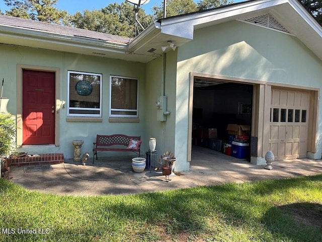 view of exterior entry with a garage