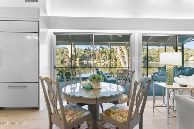 tiled dining room with a water view