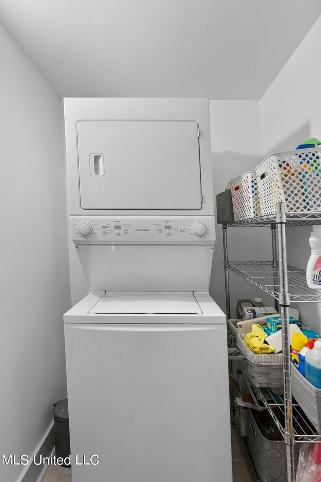 laundry room with stacked washer and clothes dryer