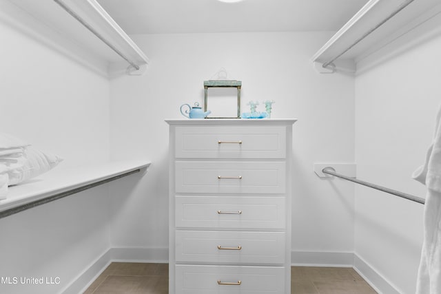 spacious closet featuring light tile patterned floors