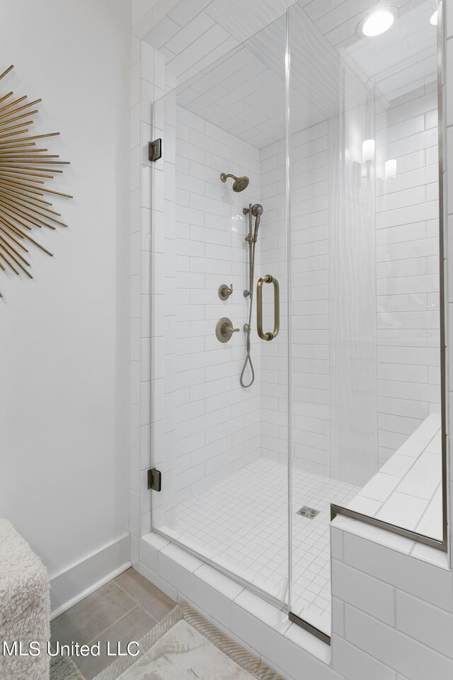 bathroom featuring a shower with door and tile patterned floors