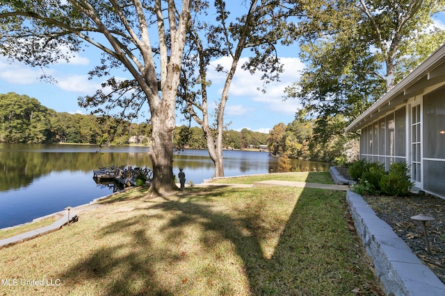 view of yard with a water view and a sunroom