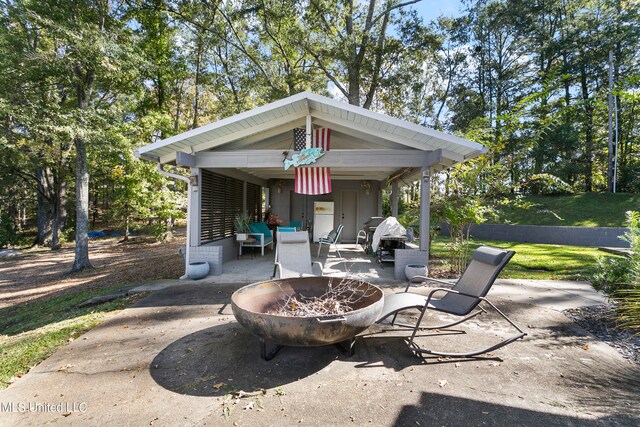 view of patio / terrace featuring an outdoor fire pit