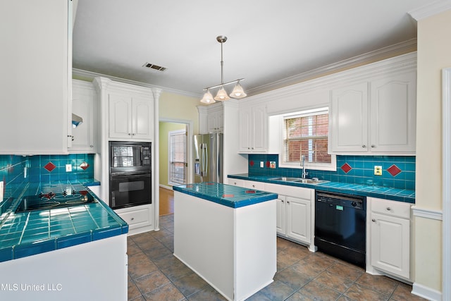 kitchen featuring tile countertops, sink, black appliances, and a kitchen island