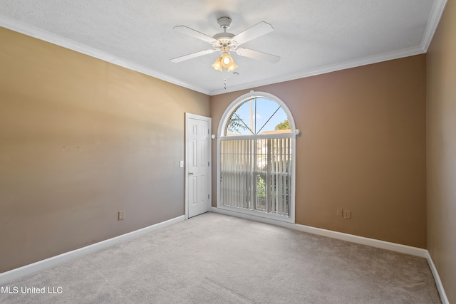 spare room with light carpet, ornamental molding, a textured ceiling, and ceiling fan