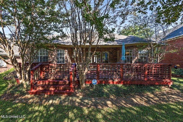 back of house with a lawn