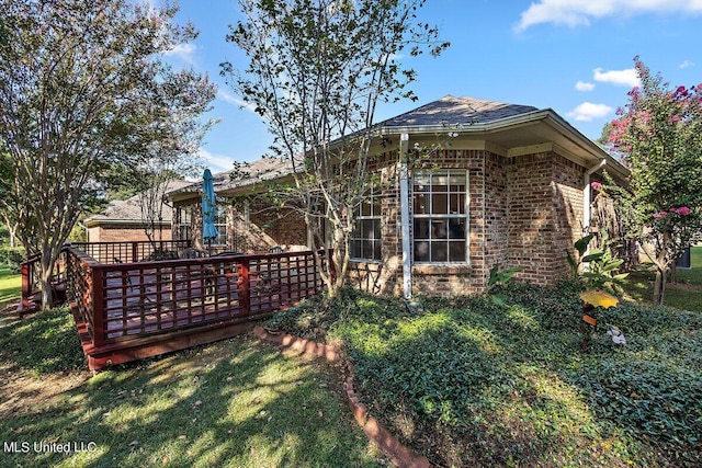 view of home's exterior featuring a yard and a deck