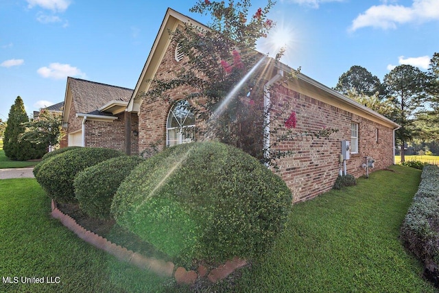 view of side of home featuring a lawn