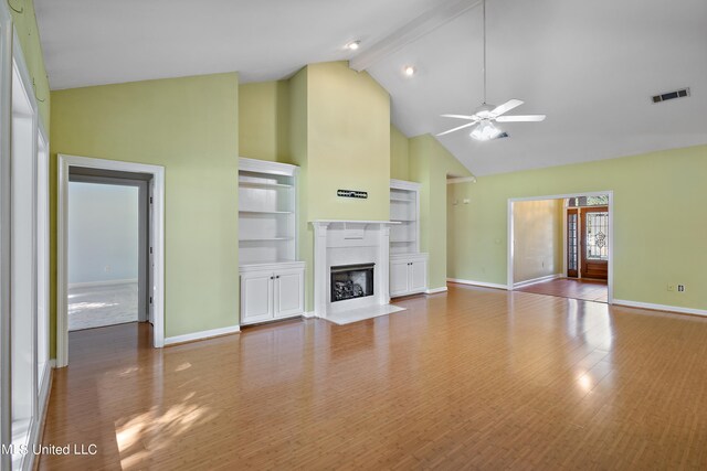 162 Apple Blossom Dr, Brandon, MS 39047 - unfurnished living room with high vaulted ceiling, a ceiling fan, baseboards, wood finished floors, and beamed ceiling