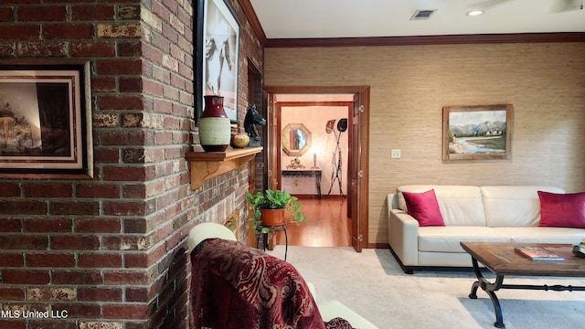 carpeted living room featuring crown molding and a brick fireplace