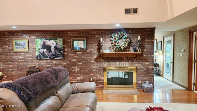 11 Aberdeen Rd, Natchez, MS 39120 - living room featuring wood finished floors, recessed lighting, a brick fireplace, and brick wall