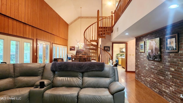 11 Aberdeen Rd, Natchez, MS 39120 - living area featuring a towering ceiling, stairway, light wood-type flooring, brick wall, and a chandelier