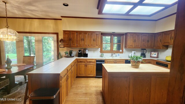 11 Aberdeen Rd, Natchez, MS 39120 - kitchen featuring a sink, a peninsula, light wood-style floors, ornamental molding, and hanging light fixtures