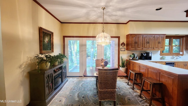 kitchen featuring a wealth of natural light, a notable chandelier, sink, and hanging light fixtures